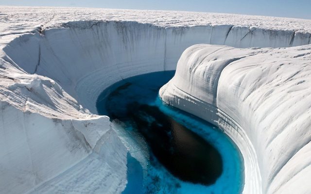 Figure 1: Greenland Ice Canyon is a beautiful example of what a partial melt can do in this iced environment. Slopes are about 30-40 m in this picture. | Credit: James Balog / National Geographic.