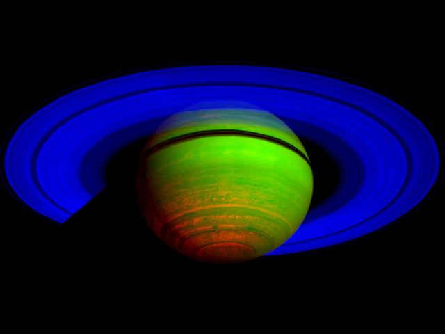 Figure 1. Saturn as seen by the Cassini Visual and Infrared Mapping Spectrometer (VIMS) on 2008. This picture is displayed in false color, being the blue and green channels the reflected sunlight at 2 and 3 μm, and the red channel corresponding to the thermal emission at 5 μm. | Credit: NASA/JPL/University of Arizona