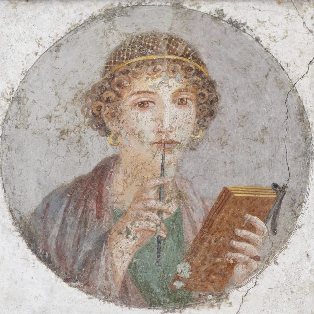 So-called Sappho: woman with a wax tablet and (chewing) a stylus. Fresco. Naples National Archeological Museum | Credit: Marie-Lan Nguyen / Wikimedia Commons