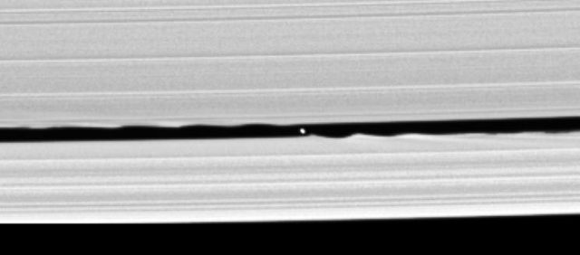Figure 2. One of the exciting images returned from Cassini spacecraft. Taken in 2005, it reveals a small object (7km wide) inside the Keeler gap called Daphnis where is also resides Pan, one of the shepherd satellites. The size of the ripples shown here allowed to estimate the size of Pan. This is just one example of the marvels found by Cassini in the last ten years. | Credit: NASA/JPL/Space Science Institute
