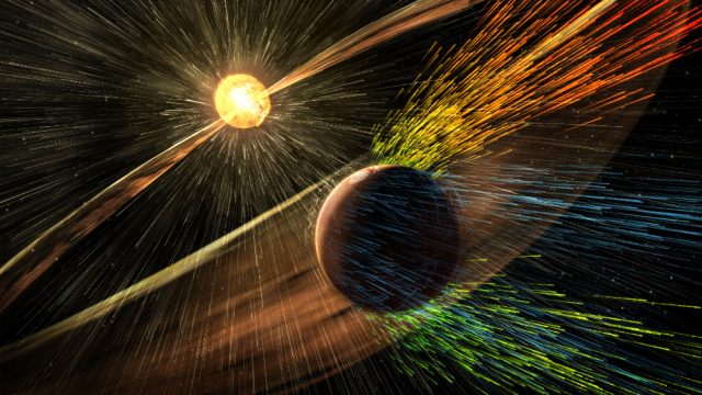 Figure 1. MAVEN has revealed how Mars' atmosphere reacts to solar wind and solar storms, as depicted in this artistic view. MAVEN has shown that the solar wind strips down Mars atmosphere mainly in two streams: the tail behind it and a polar plume perpendicular to the plane of the equator. | Credit: NASA/GSFC